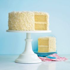 a white cake sitting on top of a plate next to a blue and white napkin