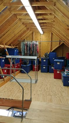 an attic with lots of storage bins and shelves