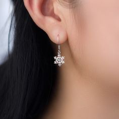 Indulge in the exquisite beauty of these stunning snowflake sterling silver dangle drop earrings, delicately crafted with 925 solid sterling silver and adorned with sparkling cubic zirconia. The intricate snowflake design exudes elegance and adds a touch of grace to your ensemble. Lightweight and comfortable, these earrings are the perfect present to show your loved ones how much they mean to you during the festive Christmas and holiday season. Embrace the magic of the snowflakes with these dazz Sparkling Snowflake Jewelry In Sterling Silver, Snowflake Shaped Sparkling Sterling Silver Jewelry, Sparkling Snowflake Sterling Silver Jewelry, Diamond White Cubic Zirconia Snowflake Jewelry, Elegant Sterling Silver Snowflake Jewelry, Fine Jewelry Snowflake Cubic Zirconia, Snowflake Shaped Cubic Zirconia Fine Jewelry, Elegant Snowflake Shaped Cubic Zirconia Jewelry, Sparkling Sterling Silver Drop Earrings