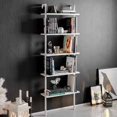 a white shelf with books on it next to a christmas tree in a living room