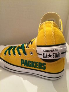 a pair of yellow converse all star sneakers