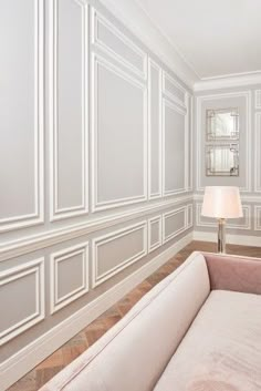 an empty room with white walls and wood flooring on the wall is pictured in this image