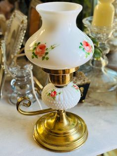 a white vase sitting on top of a table