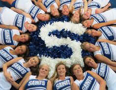 a group of cheerleaders standing in a circle together