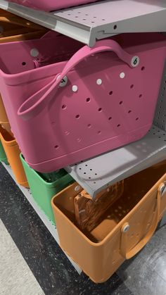 several storage bins are stacked on top of each other in different colors and sizes