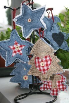 some blue and red stars are on a stand next to a potted plant in a window sill