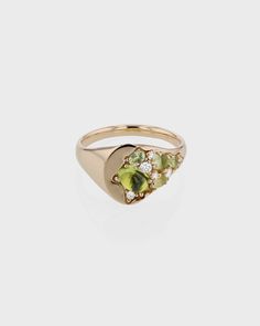 Inspired by sand at a microscopic scale, the 10-karat gold Sand Peridot Signet Ring features scattered peridots and sparkling diamonds laid in a diverse cluster on a traditional oval signet. Engagement Signet Ring, Opal Signet Ring, Peridot Ring Engagement, Signet Engagement Ring, Peridot Ring Gold, Sarah Sebastian, Heirloom Ring