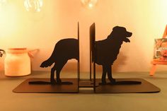 a pair of bookends with a dog cut out of it's sides