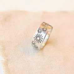 A beautiful silver band with a hand stamped suns, both big and small. Simple, but has a nice substantial presence. 9 mm wide. Sterling silver. Your ring will be made to order. Please choose your ring size during checkout. Your jewelry will arrive beautifully gift wrapped in a small box. Multiple items will be combined, unless separate boxes are requested. If this is a gift being shipped directly to the recipient, please let me know. I will be glad to include a note from you. Want to see more of Metalsmithing Jewelry Rings Simple, Thick Silver Rings, Stamped Rings, Plastic Ring, Vintage Sterling Silver Rings, Metalsmithing Jewelry, Wide Band Rings, Oxidized Silver, Choker