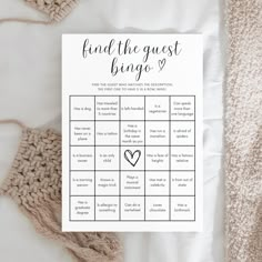 a printable find the guest bingo game on top of a white blanket with crochet