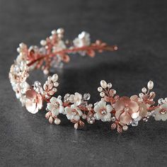 a tiara with flowers and pearls on it