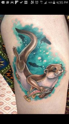 an otter tattoo on the leg of a woman's thigh, with dolphins in the background