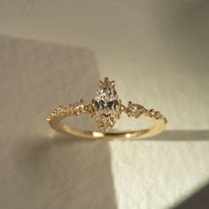 a yellow gold engagement ring with diamonds on it