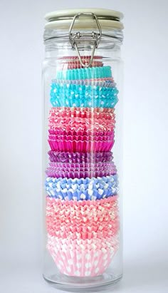 a jar filled with lots of different colored beads