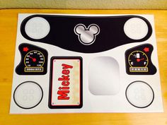 the mickey mouse decal is on top of a white board with black and red trim