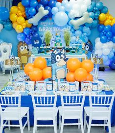 an image of a birthday party setting with balloons and decorations on the table in blue and white colors