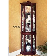 a corner display cabinet with glass doors and shelves