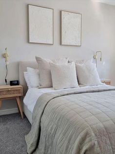 a bedroom with two paintings on the wall above the bed