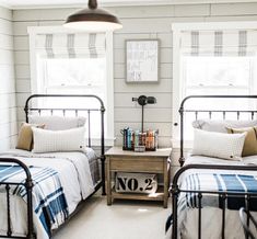 two beds in a room with white walls