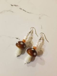 Bohemian glass mushroom earrings! Perfect addition to any outfit. 🍄  Find the matching bracelet here!: https://www.etsy.com/listing/1152358599/mushroom-beaded-bracelet-mushroom Shipping info: Your item will be shipped 1-2 business days once you place your order. Tracking is always included unless noted otherwise. For custom or wholesale items, message me on here or on Instagram @ sapphire__creations White Mushroom Design Drop Earrings, Bohemian Dangle Earrings With Mushroom Design, White Dangle Earrings With Mushroom Design, Earrings Mushroom, Mushroom Jewelry, Glass Mushrooms, Earrings Beaded, Jewelry For Her, Matching Bracelets