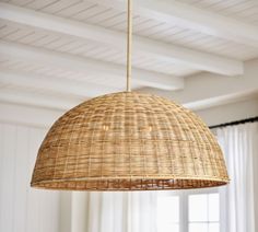 a wicker lamp hanging from the ceiling