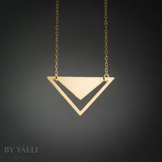 Triangle necklace - geometric triangle with V-shaped hole pendant. Featuring minimalist  silhouettes. ★ Comes in our signature gift box, ready for gift giving.  ★ Available in Gold [ gold-filled chain & gold plated brass pendant]  ★ Pendant size: 1.10"X1.80" Thanks for shopping at ByYaeli♥  All images, texts & products are property of ByYaeli ©2020 Minimalist Geometric Necklaces For Everyday, Minimalist Triangle-shaped Jewelry For Gifts, Minimalist Triangle Jewelry For Gifts, Minimalist Gold Triangle Jewelry, Minimalist Triangle Gold Jewelry, Minimalist Triangle Brass Jewelry, Minimalist Pyramid-shaped Jewelry For Gifts, Gold Triangle Necklace For Gift, Modern Gold Geometric Necklace