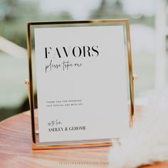 a sign sitting on top of a wooden table next to a white fluffy animal toy