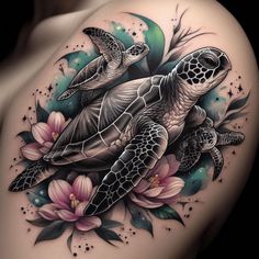 a woman's shoulder with a turtle and flowers on it