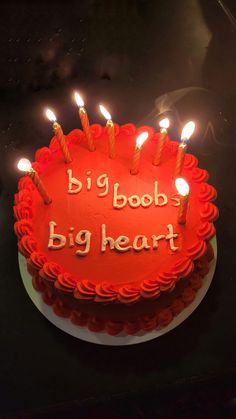 a red birthday cake with lit candles on it that says big book, big heart