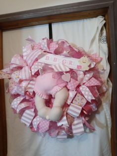 a baby wreath is hanging on the wall