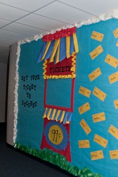 a bulletin board is decorated to look like a ticket booth with tickets on the door