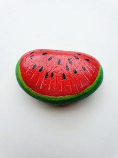 a slice of watermelon sitting on top of a white surface