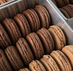 a metal container filled with lots of chocolate macaroons