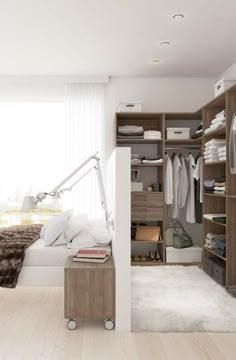 a large walk in closet with clothes on the shelves