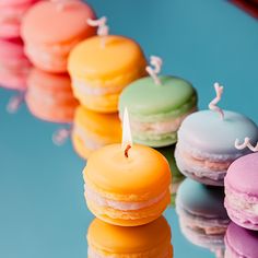 there are many macaroons with candles on the table