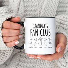 a woman holding a coffee mug with the words grandpa's fan club on it