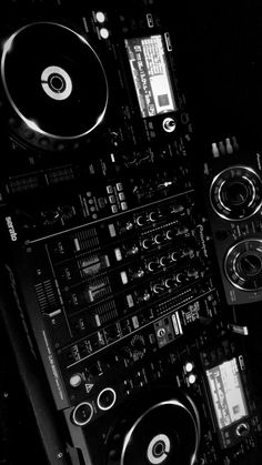 dj equipment including turntables and mixers in black and white