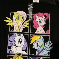 a group of little ponys on a black shirt