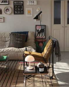 a living room filled with furniture and pictures on the wall