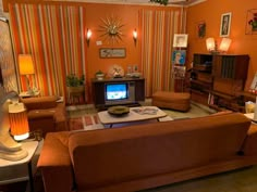 a living room filled with furniture and a flat screen tv