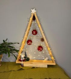 a wooden christmas tree with lights on it