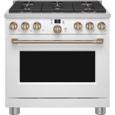 a white oven with gold knobs and two burners on the front, and an oven