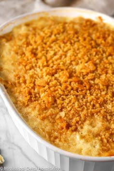 a casserole dish with crumbs in it sitting on a table next to some crackers