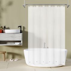 a white bath tub sitting next to a sink in a bathroom under a shower curtain