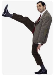 a man in a suit and tie is doing a kick with his foot on the ground