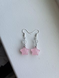 These are cute, handmade pink star earrings. Pink Beads Earrings, Cute Star Charm Dangle Earrings, Cute Dangle Earrings With Star Charm, Single Star-shaped Crystal Earring As Gift, Casual Star-shaped Jewelry For Parties, Pink Star Earrings For Party, Cute Dangle Jewelry With Star Charm, Pink Star-shaped Kawaii Jewelry, Pink Star-shaped Party Earrings