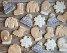 several decorated cookies are arranged on a table with snowflakes and mittenss