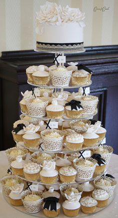 a wedding cake made out of cupcakes on a table