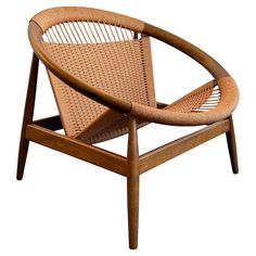 a wooden chair with wicker seat and arm rests against a white background for an interesting effect