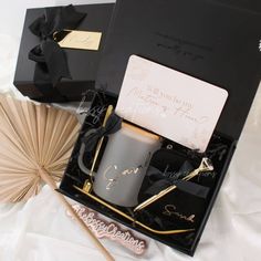 a black box with some items in it on a white sheet and an umbrella next to it